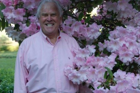 Patrick and one of his beloved Rhododendrons Patrick standing next to a rhododendron in full bloom.